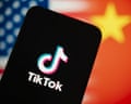 phone screen with tiktok logo, us and china flags behind it