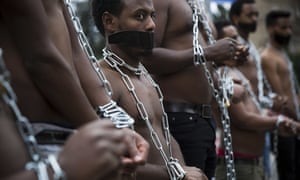 Eritrean migrants wear chains to mimic slaves at a demonstration against the Israeli government’s policy to forcibly deport African refugees and asylum seekers
