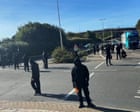 Black-clad protesters in balaclavas block road at port of Dover in Kent