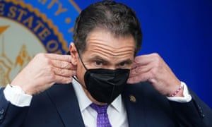 Andrew Cuomo adjusts his face mask during an event in New York City.