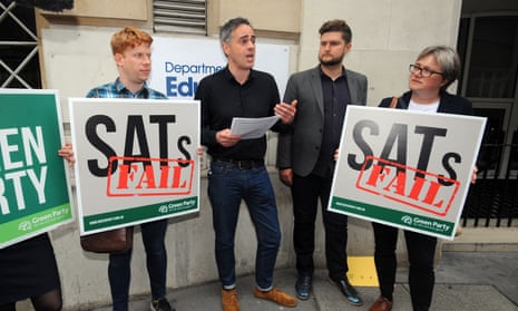 Jonathan Bartley is presented with his SATs results by a teacher outside the Department for Education in Westminster.
