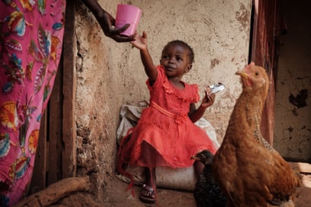 A young woman is handed a drink.