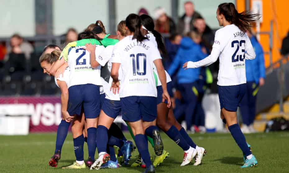 Ria Percival is mobbed by her Spurs teammates after scoring the equaliser.