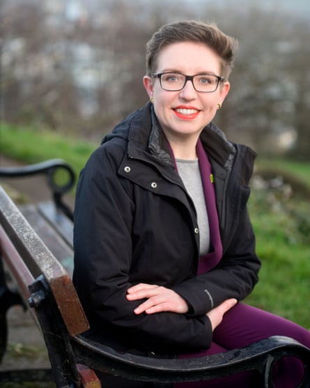 Green party co-leader Carla Denyer sat on a park bench in Bristol