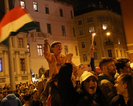 Revellers celebrate the resounding Tisza party win in Hungarian parliamentary elections in Budapest, Hungary.