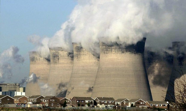 Steam rises from the cooling towers at a coal-fired power station.