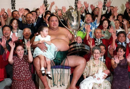 Hawaii-born champion Akebono celebrates his 10th tournament championship with his family and supporters in 2000.