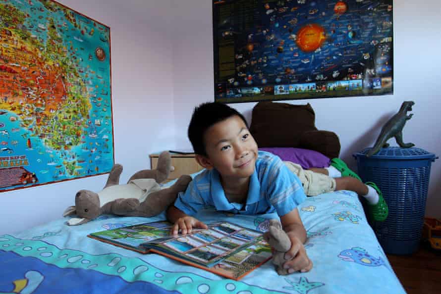 Nine-year-old James plays in his bedroom