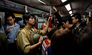 Victor Yu, a history student, rides the subway in Hong Kong on December 25, 2016 to an event marking 75 years since the British surrendered to the Japanese during World War II.