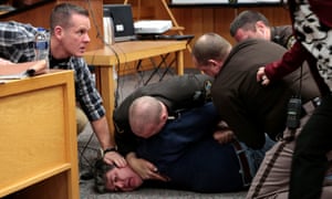 Sheriffs restrain Randall Margraves after he lunged at Larry Nassar