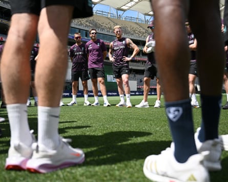 England players including Ben Stokes stand in a circle on the grass at Perth Stadium before a net session