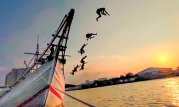 Image of children playing by jumping off a boat in the Sunda Kelapa harbour, in North Jakarta, Indonesia, with the sun nearly setting. Entitled Break the Limit it was shot in 2023 on a Xiaomi 11 Lite 5G NE.Jelly Fabrian is shortlisted in the Open Competition, Sony World Photography Awards 2024, exhibition at Somerset House 19 April – 6 May, worldphoto.org