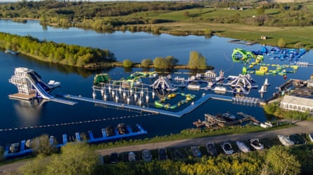 An aerial picture of an aqua park on a lake