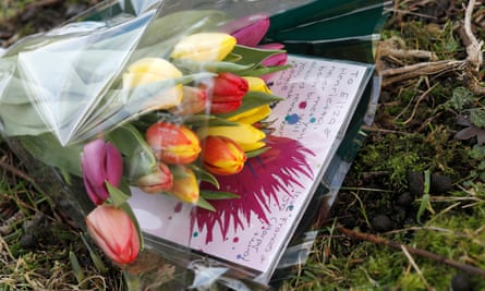 A bouquet of flowers and a card lay to Eliza and Henrietta Huszti lie on the path where the sisters were last seen.