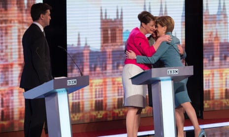 Ed Miiband looks on as Plaid Cymru Party leader Leanne Wood and Scottish National Party leader Nicola Sturgeon embrace after the BBC Challengers’ Election Debate 2015 at Central Hall Westminster, London.