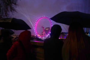 People gather on the Embankment opposite the London Eye ahead of the New Year celebrations