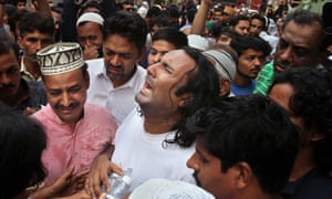 Amjad Sabri’s distraught brother, centre, after the killing on Wednesday.