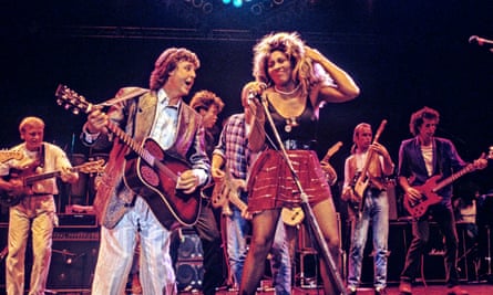 Performing with Paul McCartney at the Prince’s Trust 10th birthday party in London in 1986. Also pictured: Mark King, Paul Young, Bryan Adams, Francis Rossi and John Illsley.