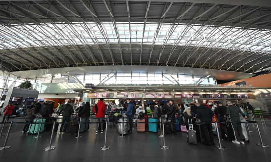 Travellers wait at  check-in counters on Sunday at  Boryspil airport outside Kyiv