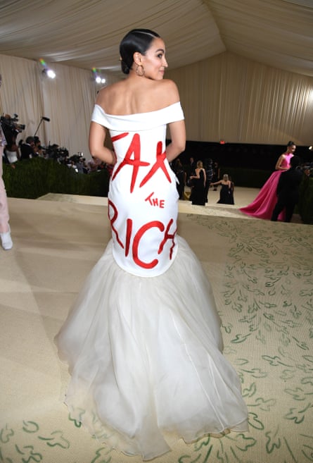 US Democratic congresswoman Alexandria Ocasio-Cortez attends the 2021 Met Gala wearing a white dress with Tax The Rich written in red across the back
