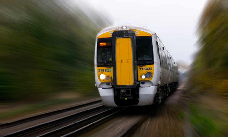 A modern train speeds down a track