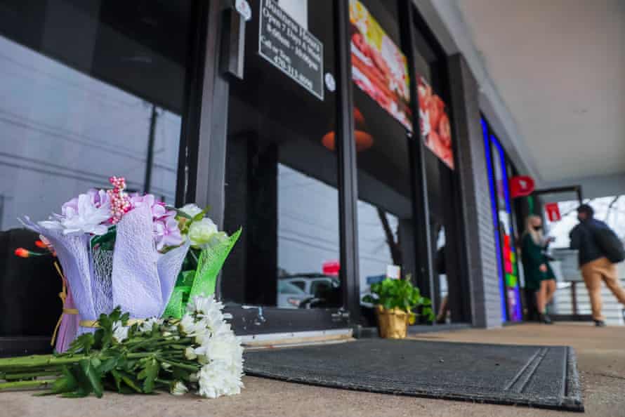 Flowers left by well-wishers sit at the entrance to Young’s Asian Spa.