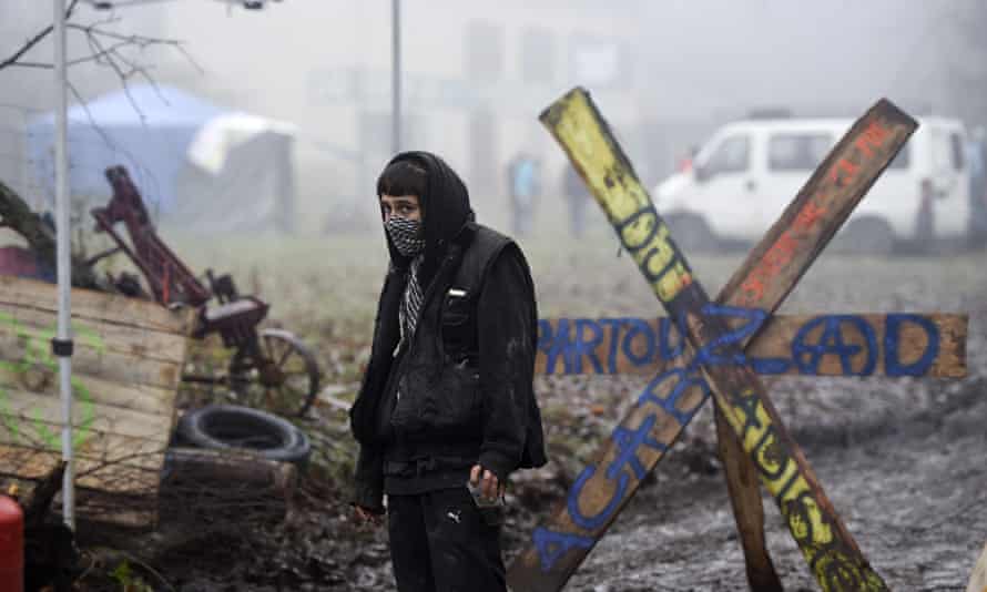 An activist guards a makeshift checkpoint at the protest site in the Chambaran forest in Roybon, France.