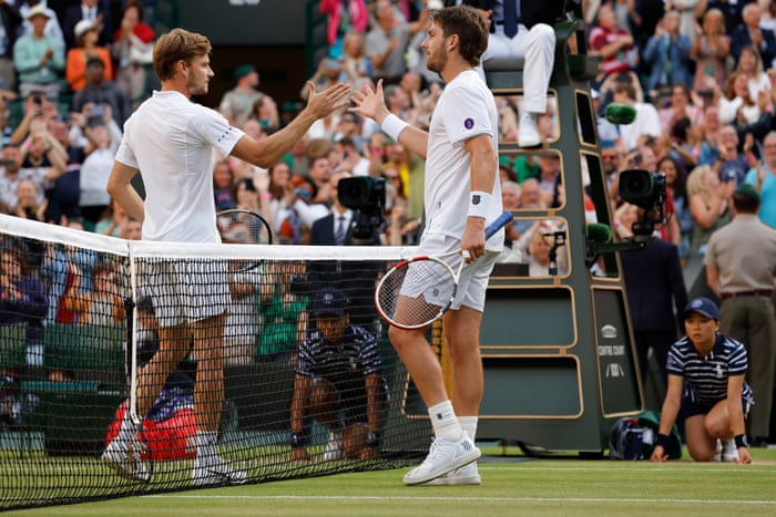 Cameron Norrie (right) shakes hands with David Goffin after his victory in their men’s singles quarter-final match.