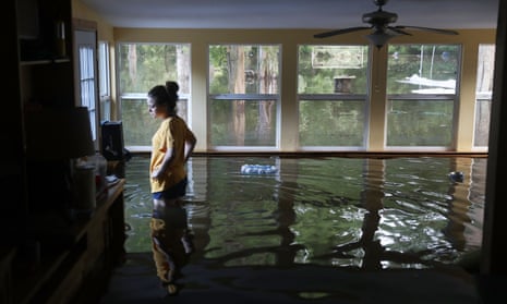 Leslie Andermann Gallagher surveys the flood damage to her home in Sorrento, Louisiana