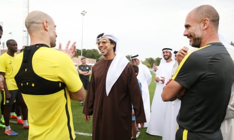 Sheikh Mansour with Manchester City player Pablo Zabaleta and manager Pep Guardiola at a mid-season training camp in Abu Dhabi in February last year