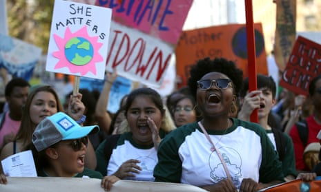 Young activists and their supporters hold signs as they march Friday during a Global Climate Strike demonstration in San Francisco.