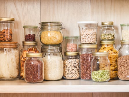 Kitchen drawer with glass jars filled with beans, pasta and nutes