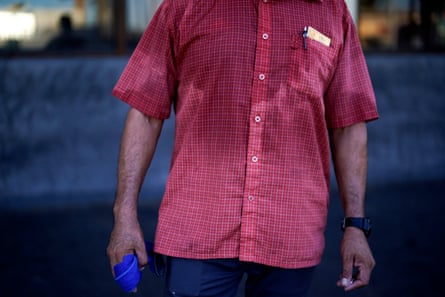 Pablo Suarez’s shirt is bathed in sweat before 7am as he parks cars and provides security for a downtown cafe in Mexicali, Mexico, on 20 July 2023.