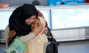 A woman greets her mother after she arrived from Dubai on Emirates flight 203 at John F Kennedy airport in Queens, New York.