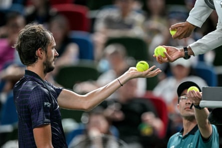 Daniil Medvedev collects balls during his against Learner Tien at the Shanghai Masters