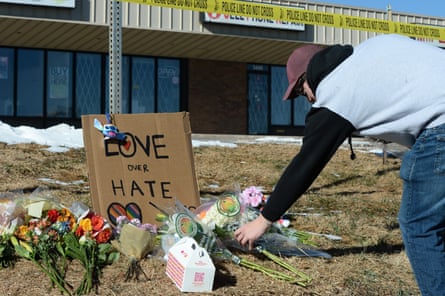 Elijah Newcomb lays flowers near a gay nightclub in Colorado Springs, Colorado, on Sunday, where a shooting occurred late Saturday night.