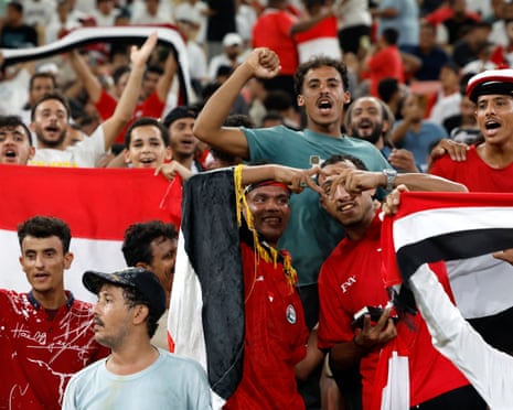 Yemen fans make a heart with their fingers as they cheer on their side before the Gulf Cup match against the UAE