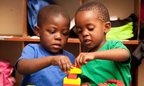 Two children playing with Lego