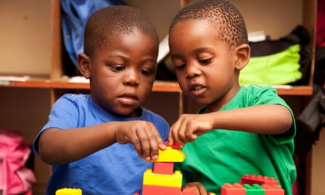 Two children playing with Lego