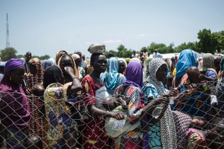 Women and children queue to enter a Unicef nutrition clinic in Muna informal settlement on the outskirts of Maiduguri, the capital of Borno state in north-east Nigeria