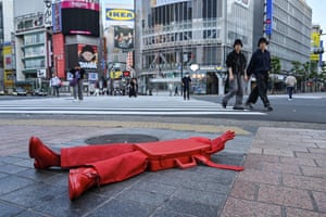 A red art installation called The Briefcase is displayed at Shibuya crossing in Tokyo