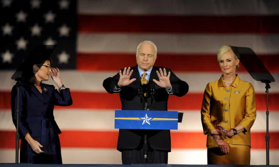 On 4 November 2008, McCain, flanked by running mate Sarah Palin and his wife Cindy, gives his concession speech after losing the presidency to Barack Obama.