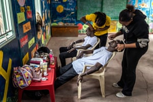 Young men having their makeup done in a classroom