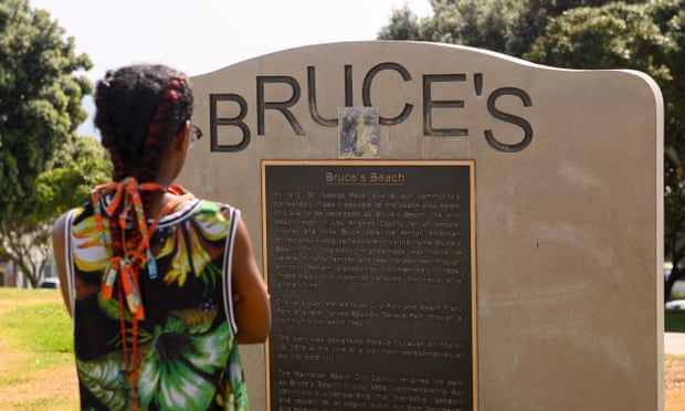 A person reads a plaque at Bruce's Beach park on April 20, 2021 in Manhattan Beach, California. 