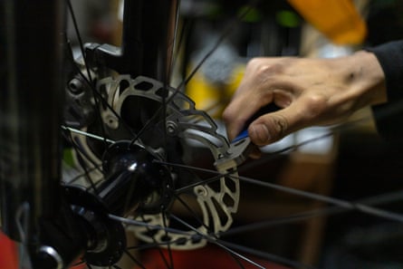 A closeup of the maintenance and straightening of the front wheel brake disc of a 29-inch bicycle rim