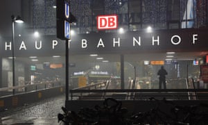 Police officers guard the entrance to the closed central station in Munich.