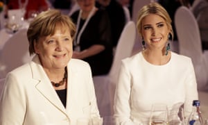 Angela Merkel sits next to Ivanka Trump in her mismatched earrings in Berlin this week.
