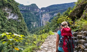 Tourist on hiking trail looking at Gocta waterfall