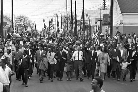 Martin Luther King, center, leads marchers across the Alabama river during the march to the state capitol at Montgomery.