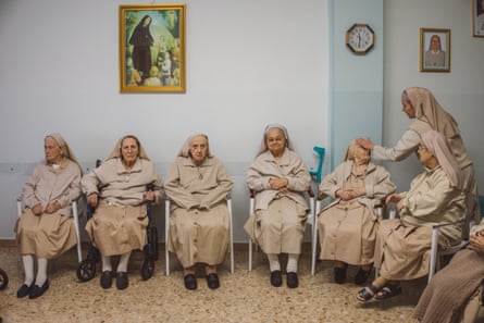 Nuns sitting on chairs.